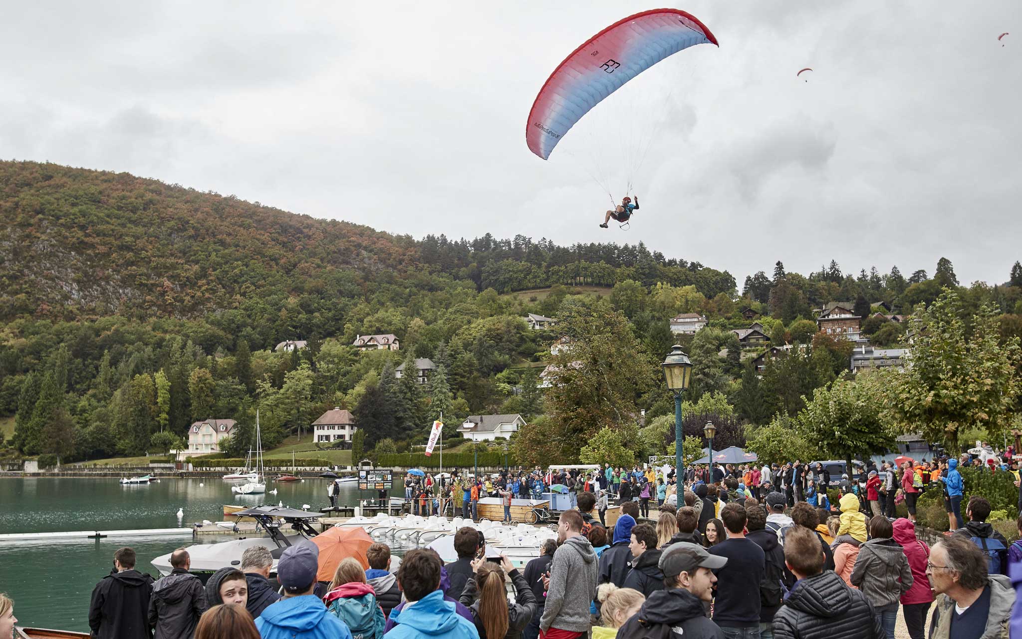 Participants paraglide above the crowd at the Red Bull Elements in Talloires, France on September 17th, 2016. // Tim Lloyd / Red Bull Content Pool // P-20160917-01655 // Usage for editorial use only // Please go to www.redbullcontentpool.com for further information. //