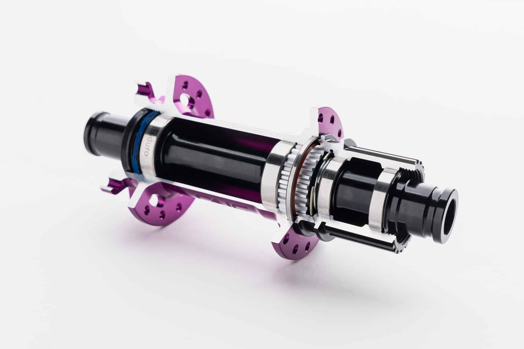 https://www.vojomag.com/app/uploads/2024/06/OneUp Components Hubs Cross Section Purple Iso.jpg