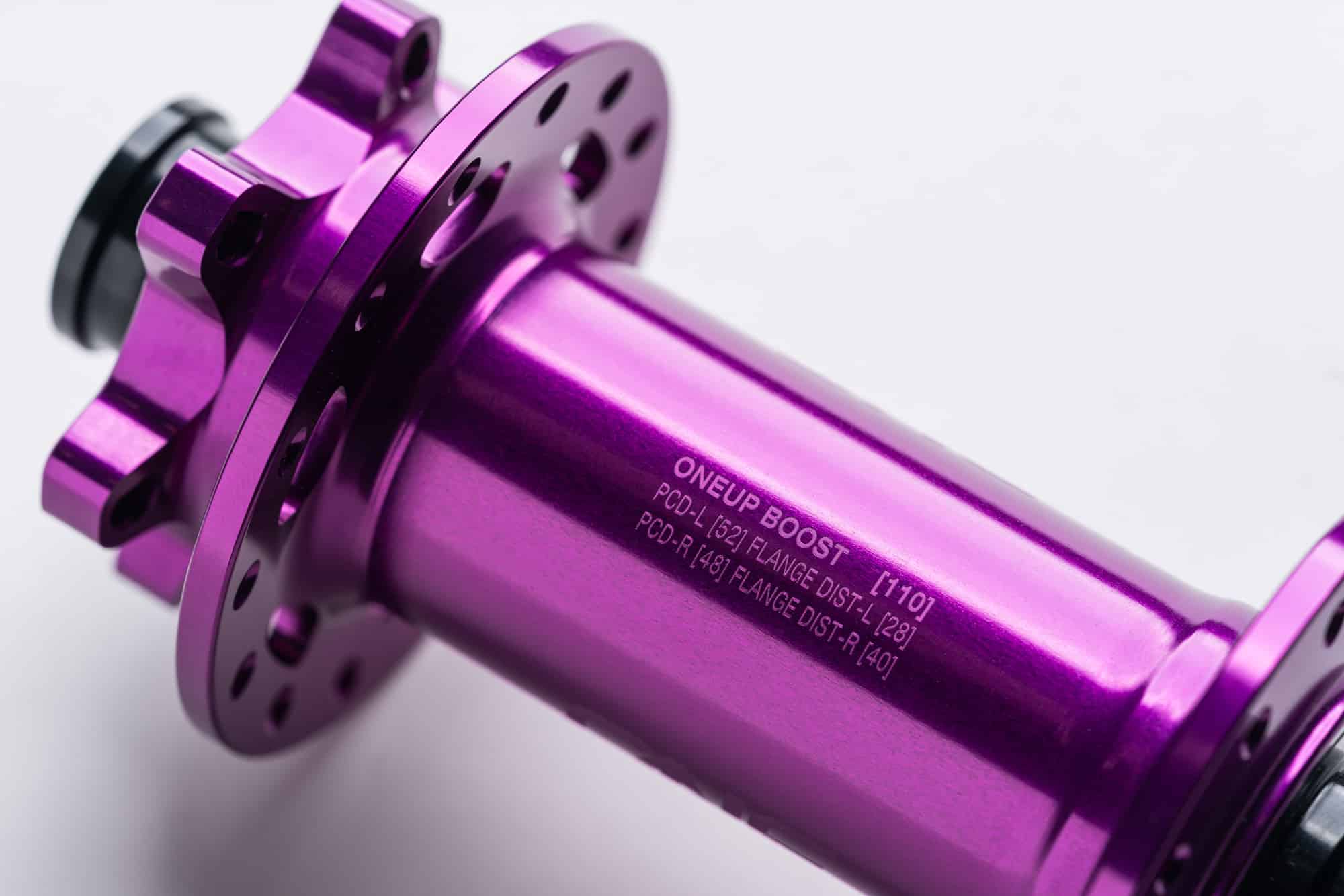 https://www.vojomag.com/app/uploads/2024/06/OneUp Components Rear Hub Wheelbuild SpecsPurple.jpg