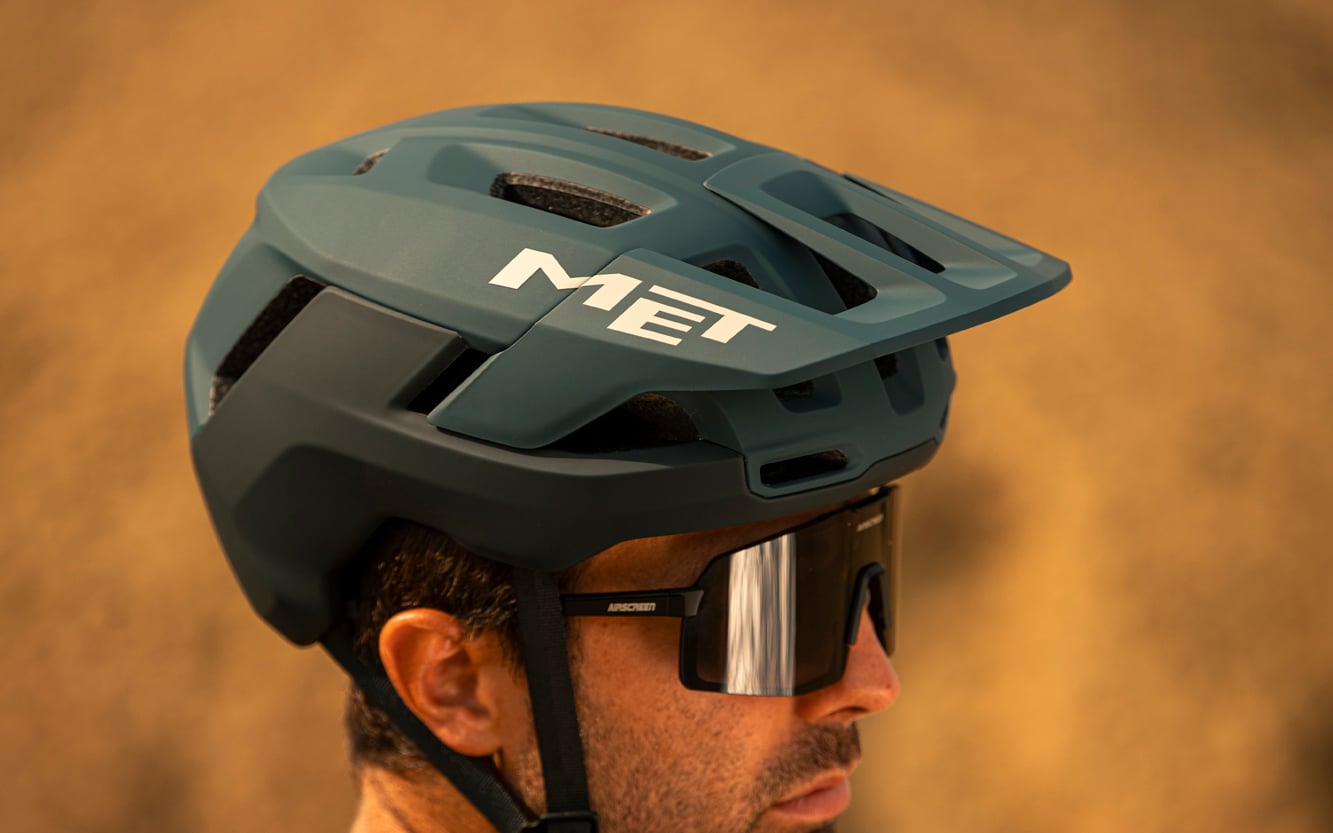 https://www.vojomag.com/app/uploads/2025/07/met terrae mips mtb helmet action image burned yellow.jpg